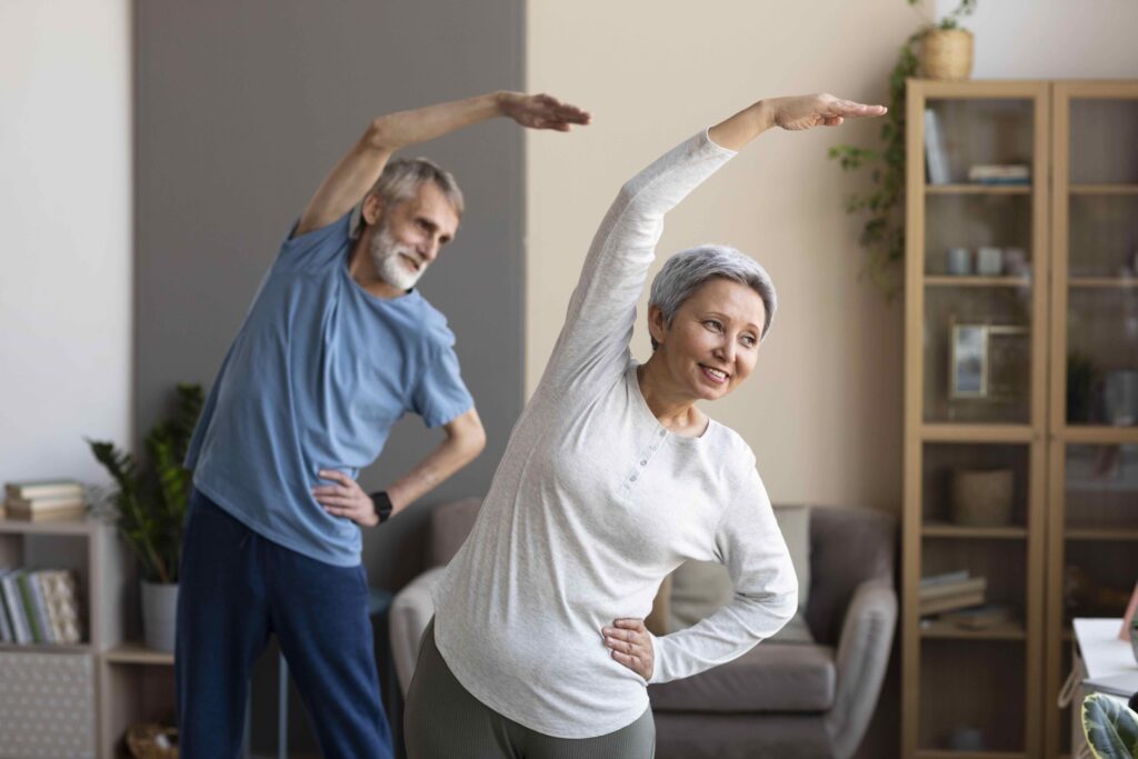 Senior Couple Exercising At Home