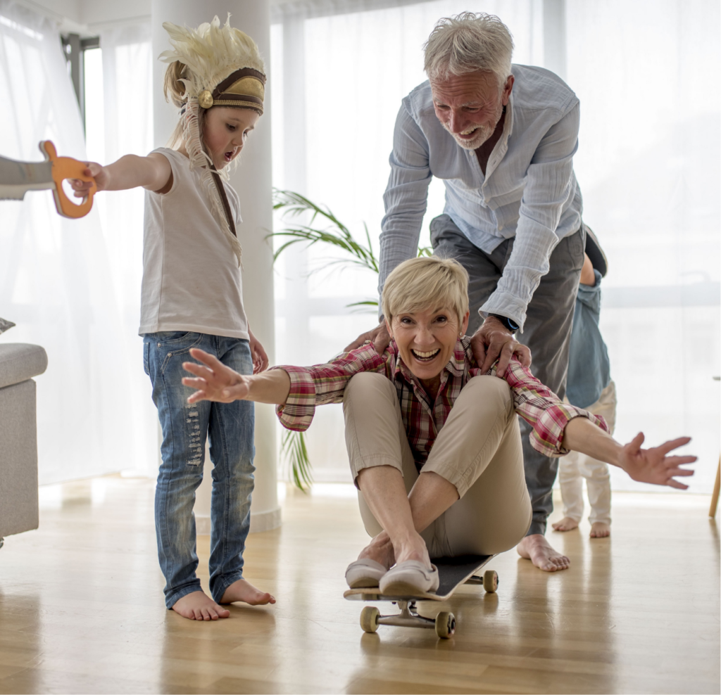 Grandfather Pushing Grandmother Skateboard With Grandson